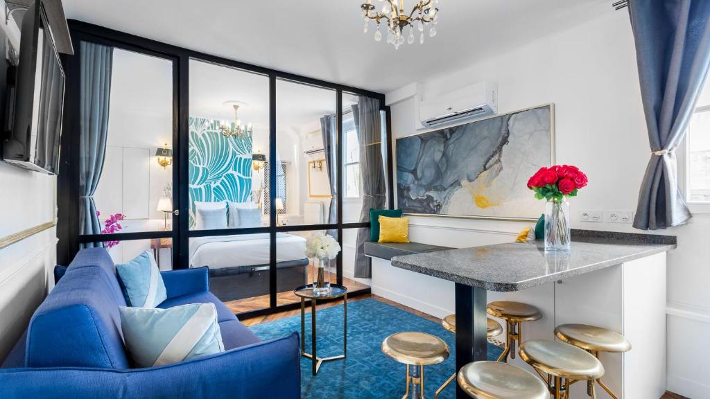 パリにあるLuxury 2 Bedroom - Louvre & Champs Elyseesのリビングルーム(青いソファ、テーブル付)