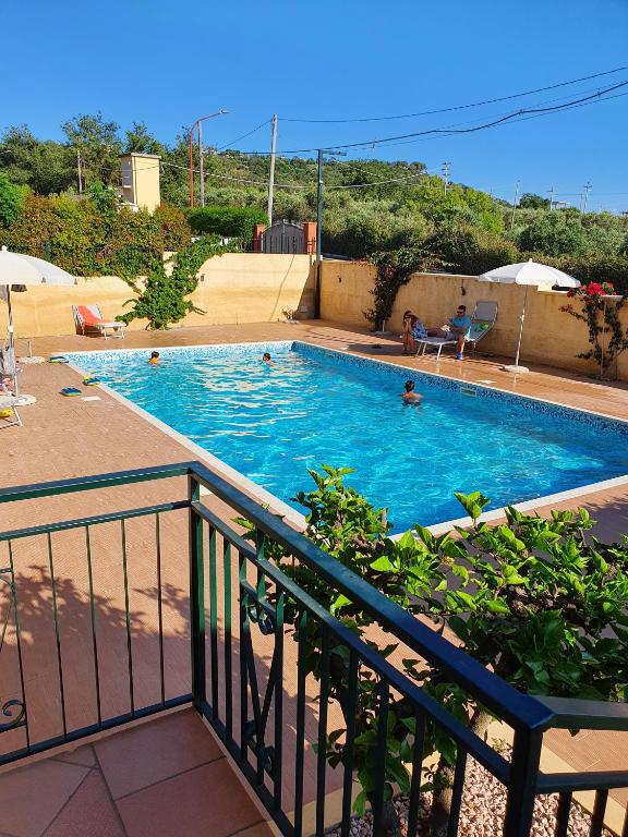 a large swimming pool with people in the water at Residenza Laura Casa Vacanze Capo Vaticano in Capo Vaticano
