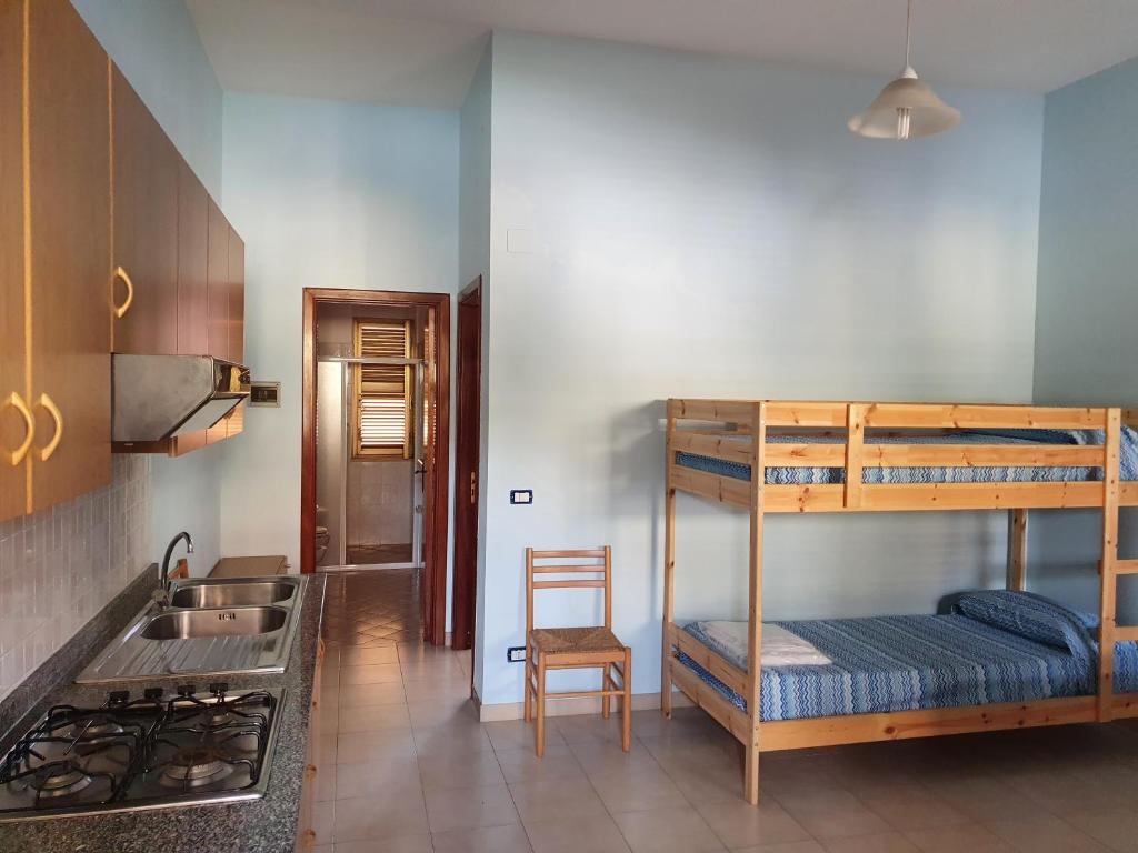 Ένα ή περισσότερα κρεβάτια σε δωμάτιο στο Laura Casa Vacanze Capo Vaticano