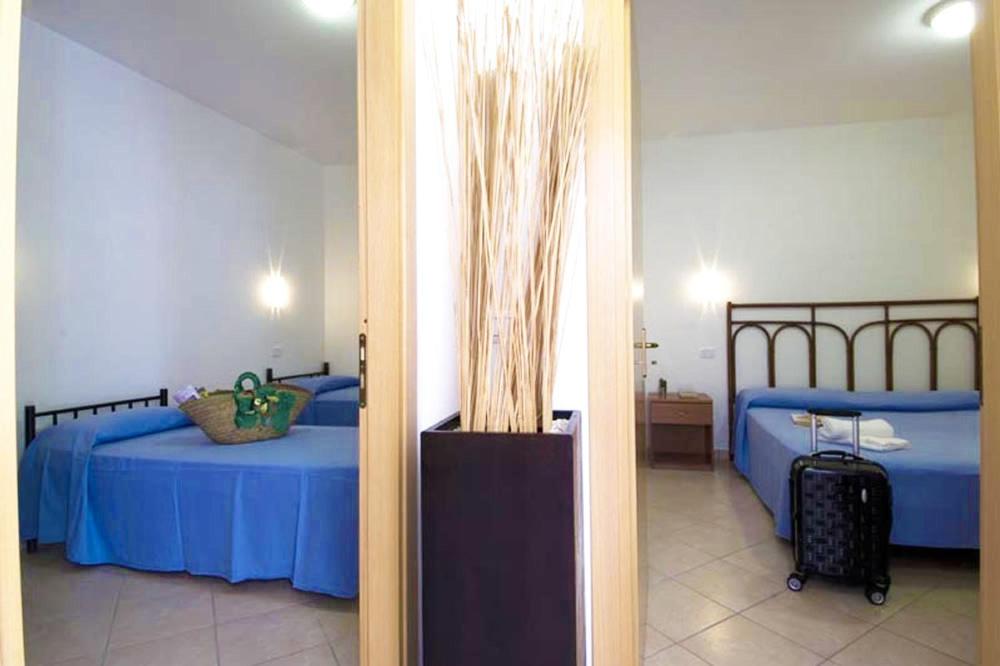 Postel nebo postele na pokoji v ubytování Villaggio Le Palme
