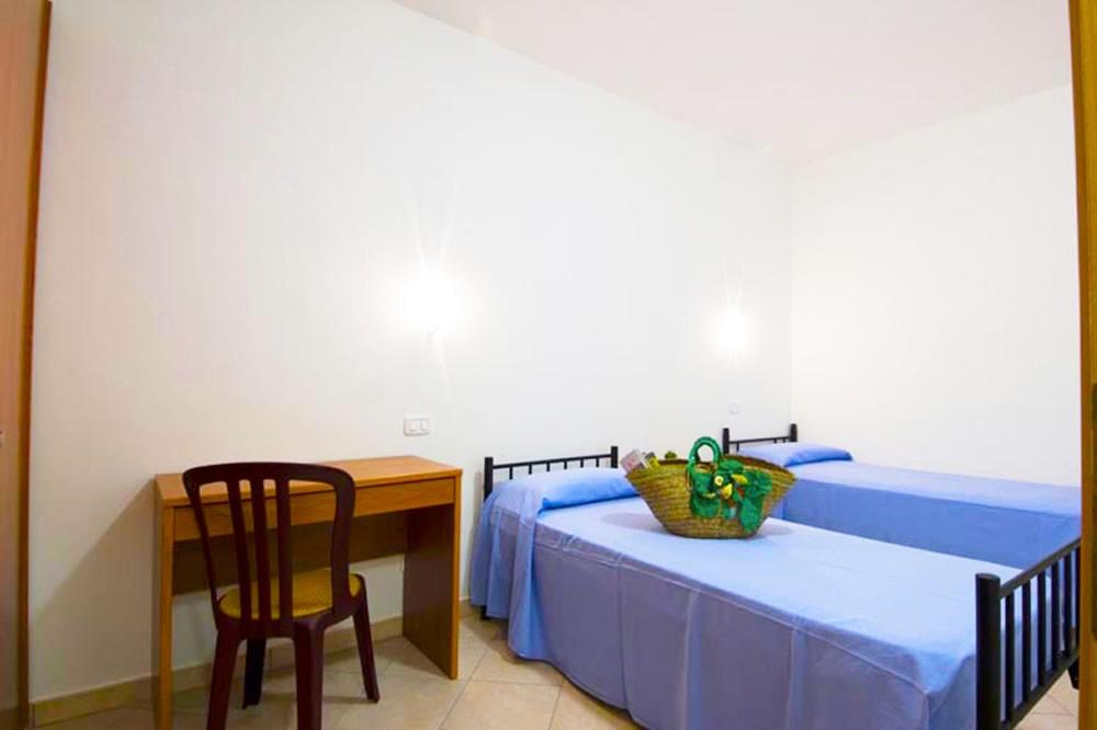 Postel nebo postele na pokoji v ubytování Villaggio Le Palme
