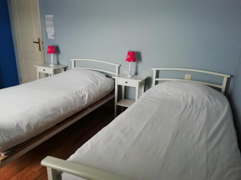 Postel nebo postele na pokoji v ubytování La Ferme Oubliée