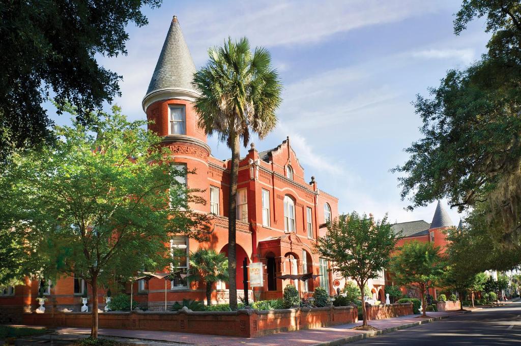 
a tall brick building with a clock tower at Mansion on Forsyth Park, Kessler Collection in Savannah
