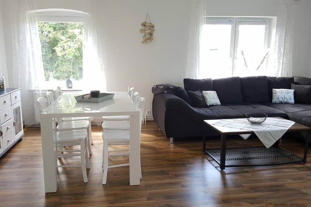 a living room with a couch and a table at Gemütliche Haushälfte mit Garten und Terrasse in Flensburg