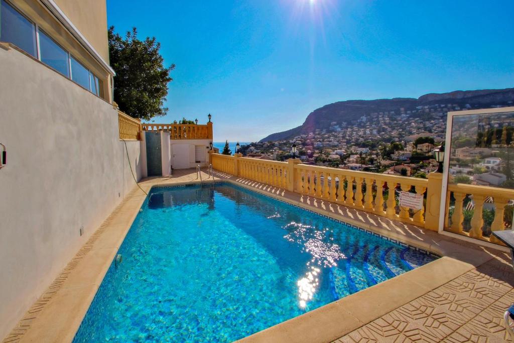 a swimming pool on a balcony with a view of the city at Tosal Julia - sea view villa with private pool in Calpe in Calpe