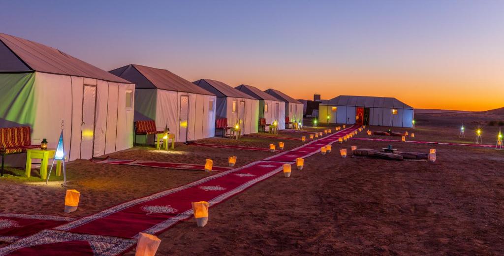 a row of houses in the desert at sunset at Luxury Bega Camp in Merzouga