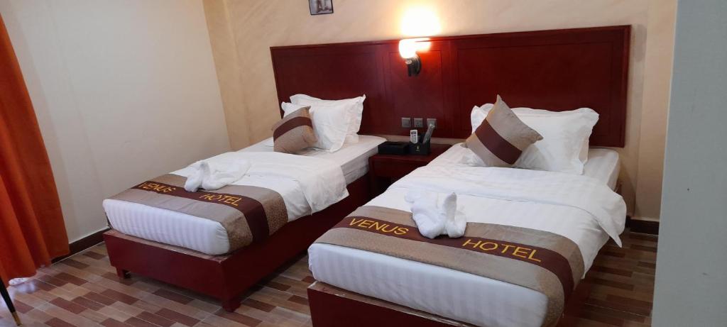 Postel nebo postele na pokoji v ubytování Venus Hotel