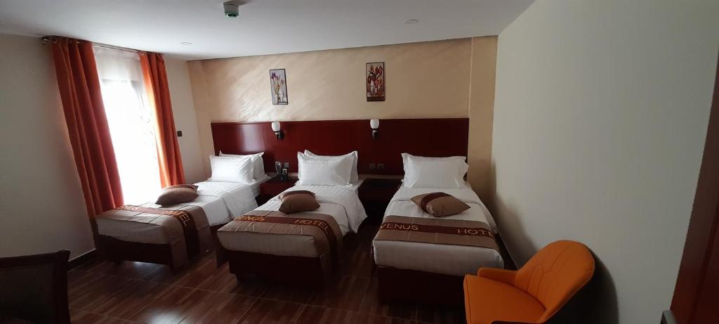 Postel nebo postele na pokoji v ubytování Venus Hotel