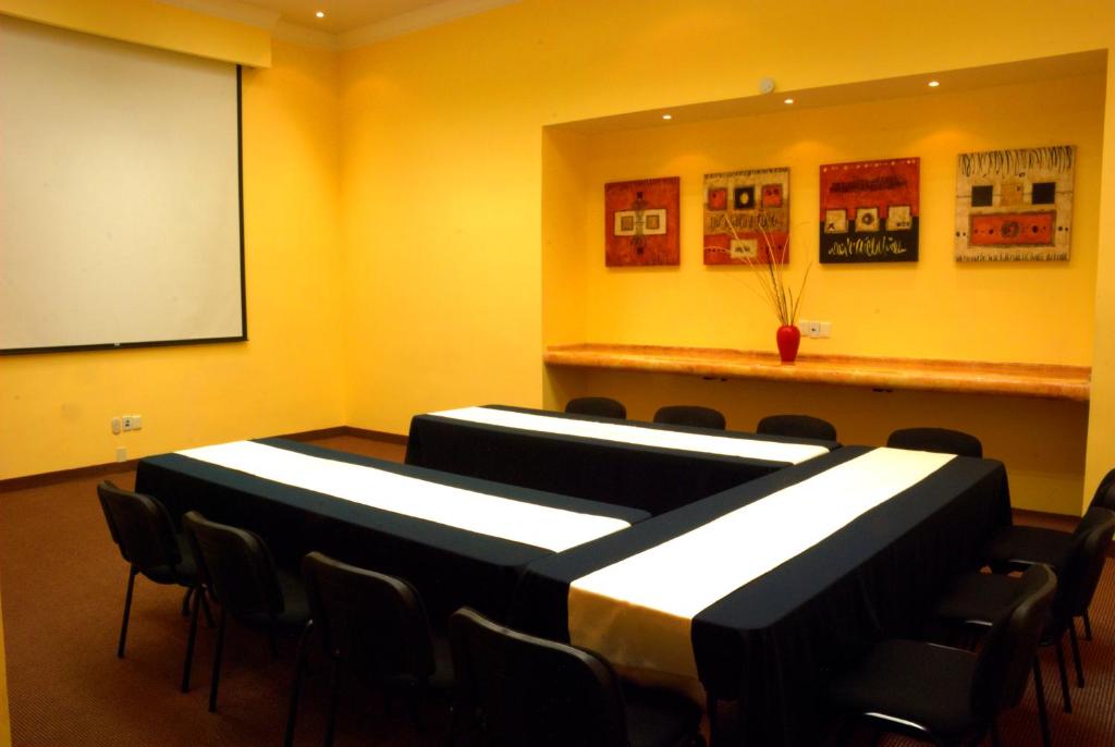 a conference room with chairs and a white board at Gran Hotel de Querétaro in Querétaro