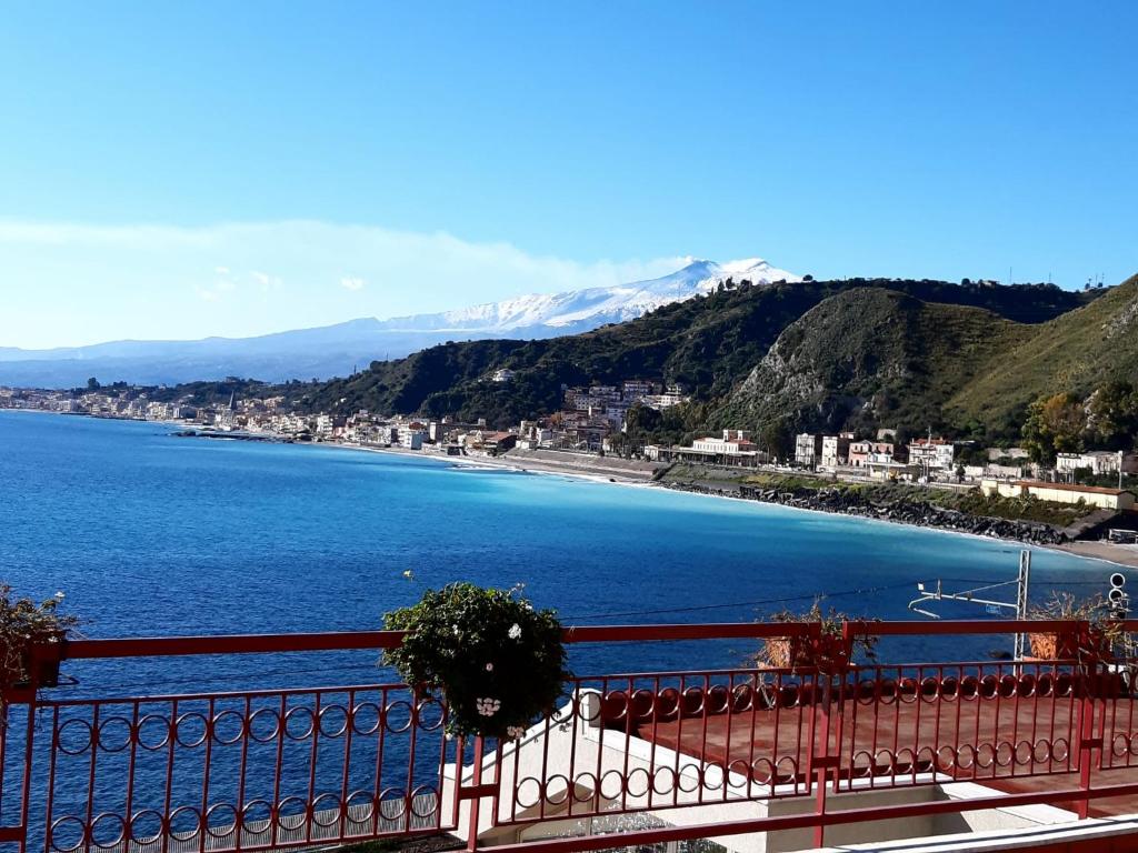 a view of a beach from a balcony at WHITE LOTUS Apartment in Taormina