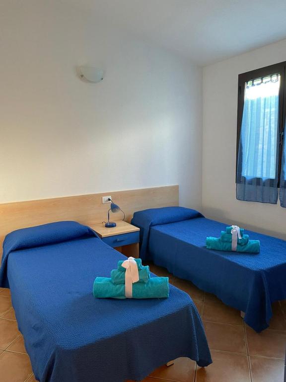 Łóżko lub łóżka w pokoju w obiekcie Case Vacanze Sole e Luna
