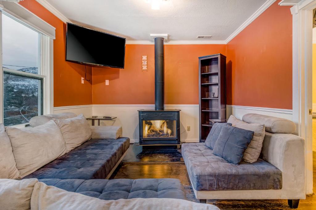 a living room with two couches and a fireplace at Park City Bliss in Park City