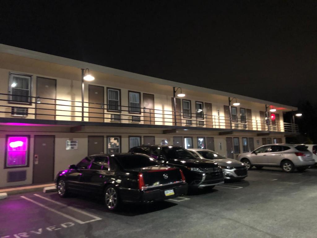 a group of cars parked in a parking lot in front of a building at Trolley Stop Motel, Media ,Near PHL Airport PA in Media