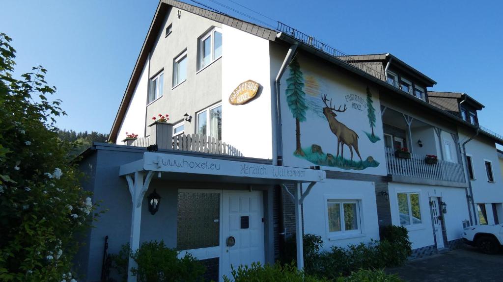 a building with a deer painted on the side of it at Gästehaus Hoxel in Hoxel