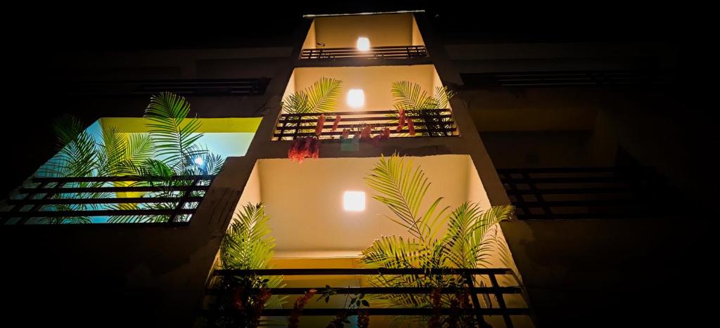 a night view of a building with stairs and plants at The White Canyon Hotel in Varanasi