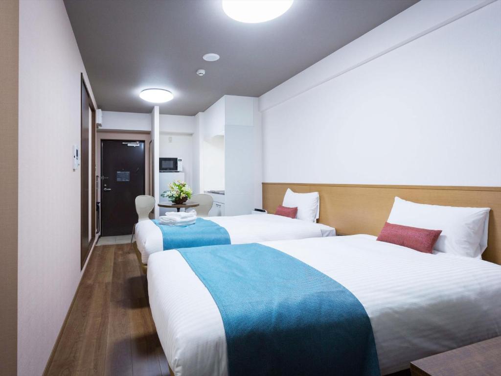 Postel nebo postele na pokoji v ubytování Ryujin Hotel Ukishima