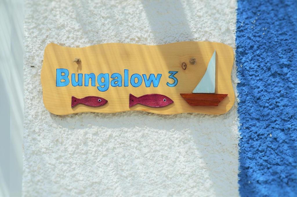 a sign for a bed with a sailboat on it at Summer Residence in Provatas