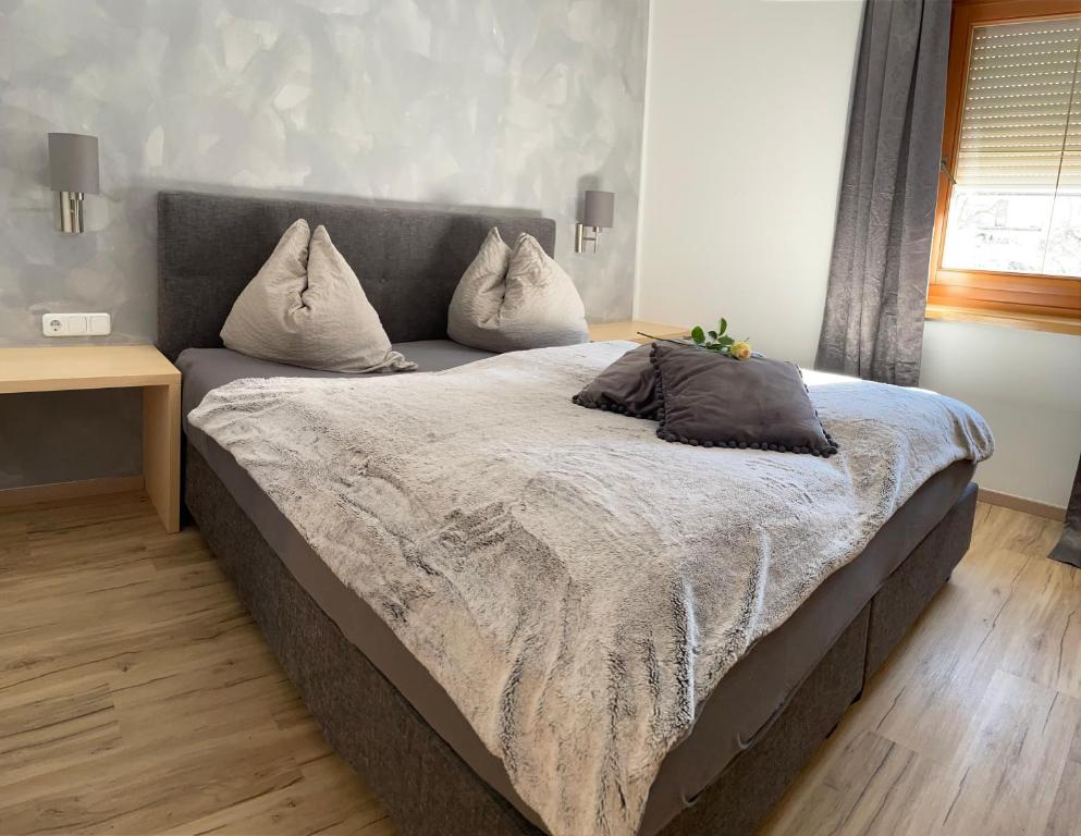 a bed with two pillows on it in a bedroom at Schusterhof Dölsach in Dölsach