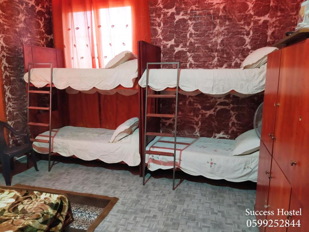 Postel nebo postele na pokoji v ubytování Success Hostel