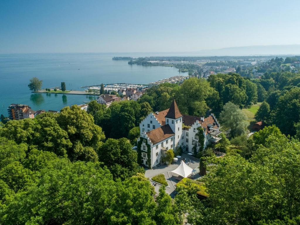 an aerial view of a house on the shore of a lake at Schloss Wartegg in Rorschacherberg