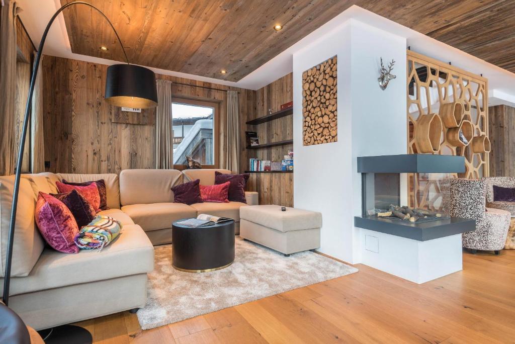 a living room with a couch and a fireplace at Paruda Mountainchalet in Ortisei