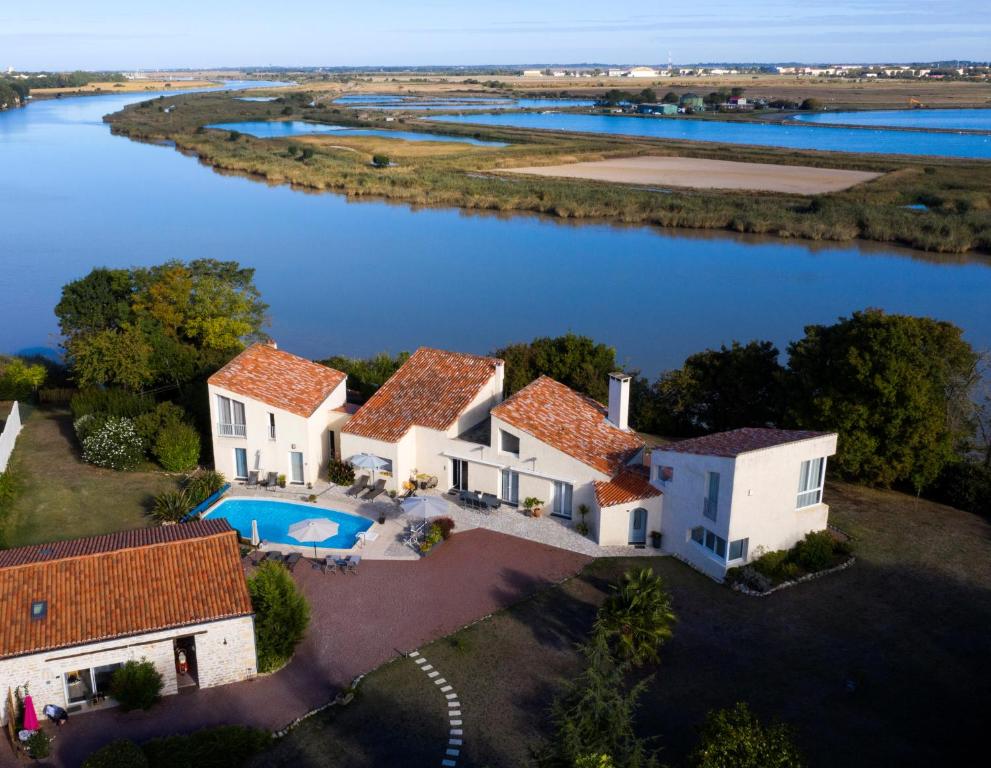 an aerial view of a house with a river at La Charentine in Échillais