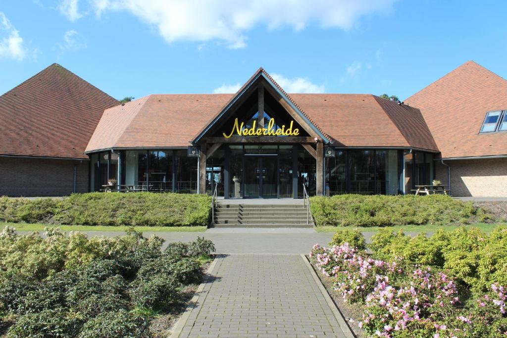a building with a sign on the front of it at Hotel restaurant Nederheide in Milheeze