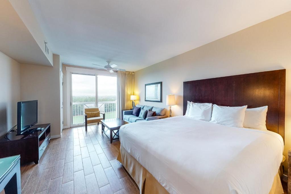 a hotel room with a large bed and a television at Sandestin Elation #5616 in Destin
