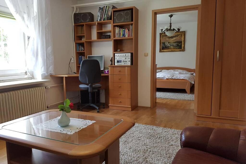 a living room with a desk and a bedroom at Welcome to enjoy Maribor ! in Maribor