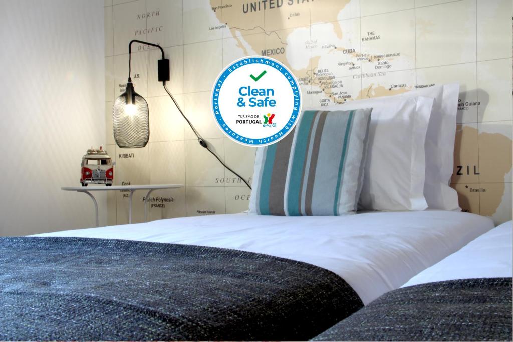 uma cama com uma placa que diz limpo e seguro em Travellers Pearl by Storytellers no Funchal