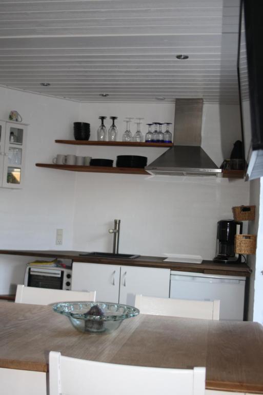 a kitchen with a table with chairs and a counter top at Holiday-Skagen in Skagen