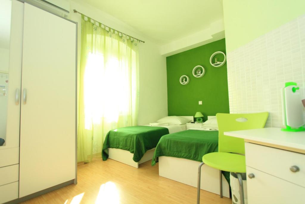 Postel nebo postele na pokoji v ubytování Nirvana Rooms & Apartments