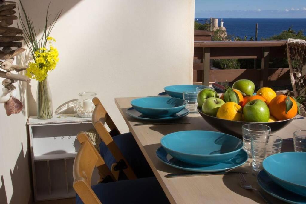 a table with a bowl of fruit on top of it at Miramar in Cala Figuera