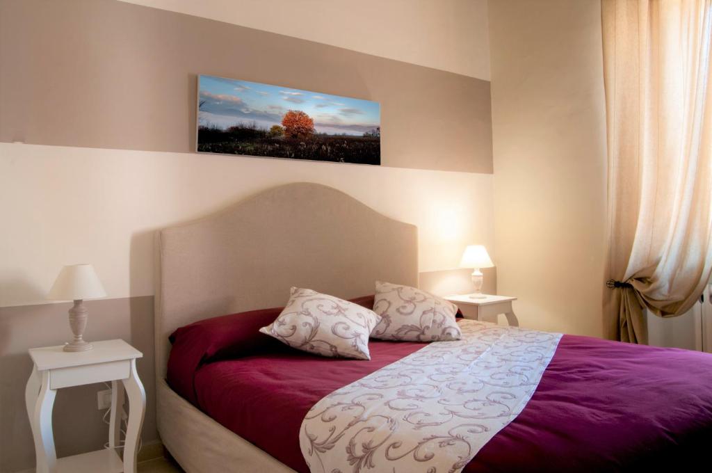 a bedroom with a purple bed with two pillows at Sguardo sul Corso in Boiano