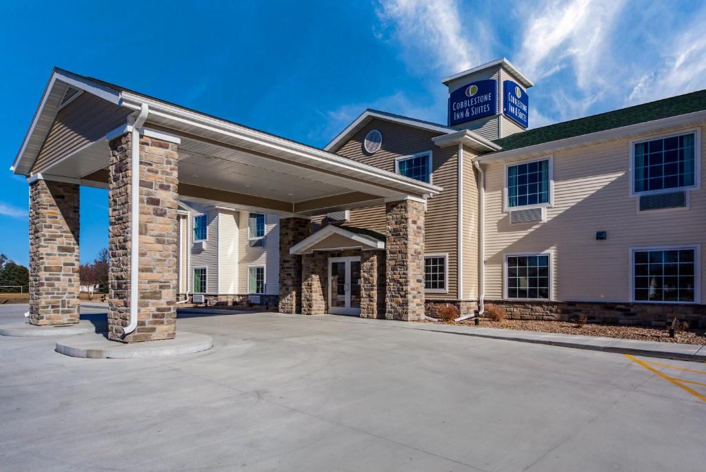 a building with a parking lot in front of it at Cobblestone Inn & Suites - Holdrege in Holdrege