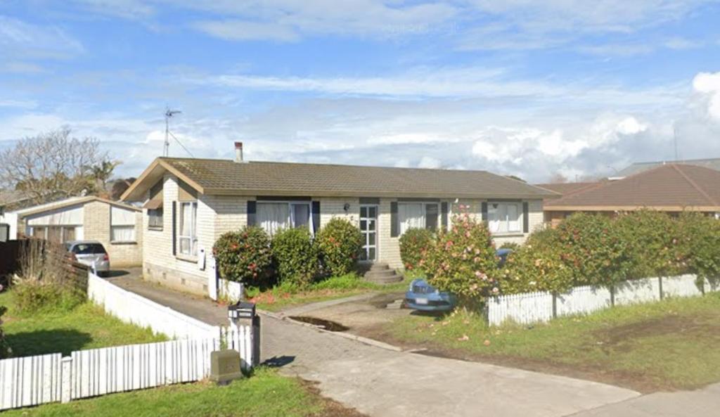 a house with a white fence in front of it at Papamoa Budget Accommodation in Papamoa