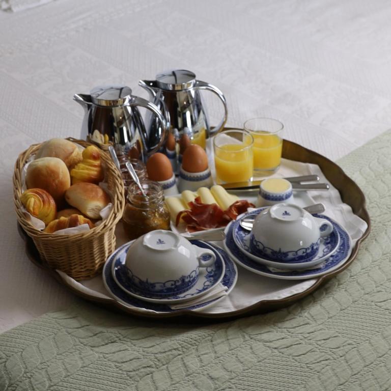 a tray of breakfast food on a table at Hotel Portofoz in Porto