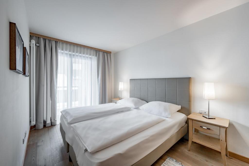 Posteľ alebo postele v izbe v ubytovaní Apartment Torri di Seefeld