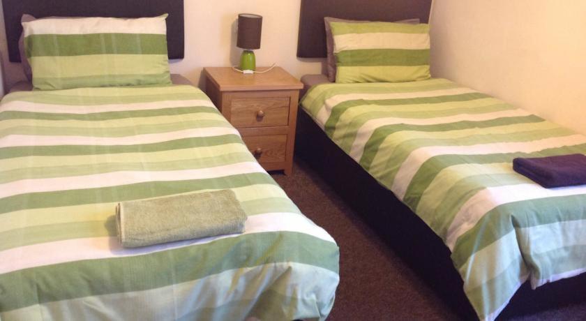 two beds sitting next to each other in a room at Claydens in Cleethorpes