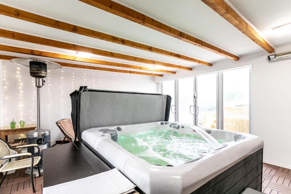 a bathtub in the middle of a room at Kaktusz Villa Heviz in Hévíz