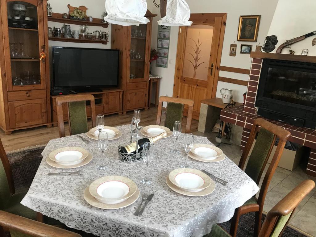 a dining room with a table with plates on it at Къща за гости - Еделвайс, гр. Габрово in Gabrovo