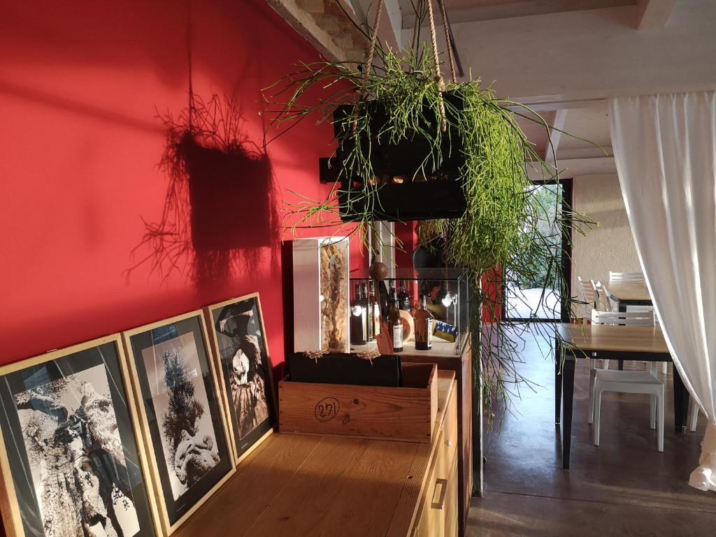 a room with a red wall with pictures and a table at Tenuta San Marcello in San Marcello