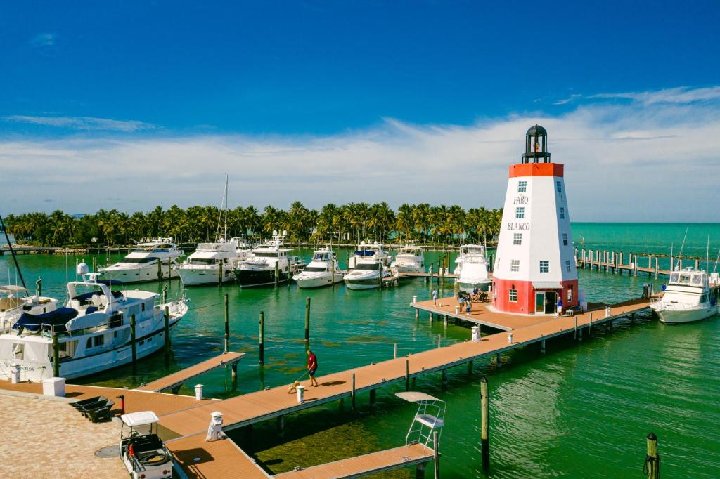 a harbor with boats docked and a lighthouse at Faro Blanco Resort & Yacht Club in Marathon