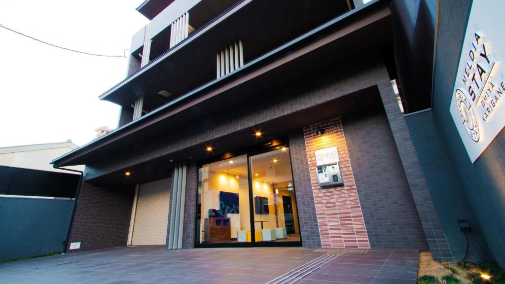 a store front of a building with its doors open at Meldia Stay Omiya KARIGANE in Kyoto