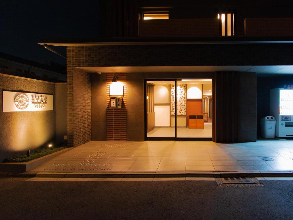 a front entrance to a building at night at Meldia Stay Nijojo IWAGAMI in Kyoto