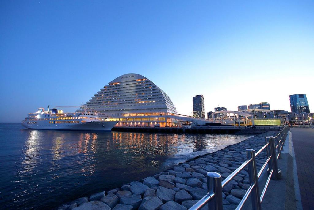a cruise ship is docked next to a building at Kobe Meriken Park Oriental Hotel in Kobe