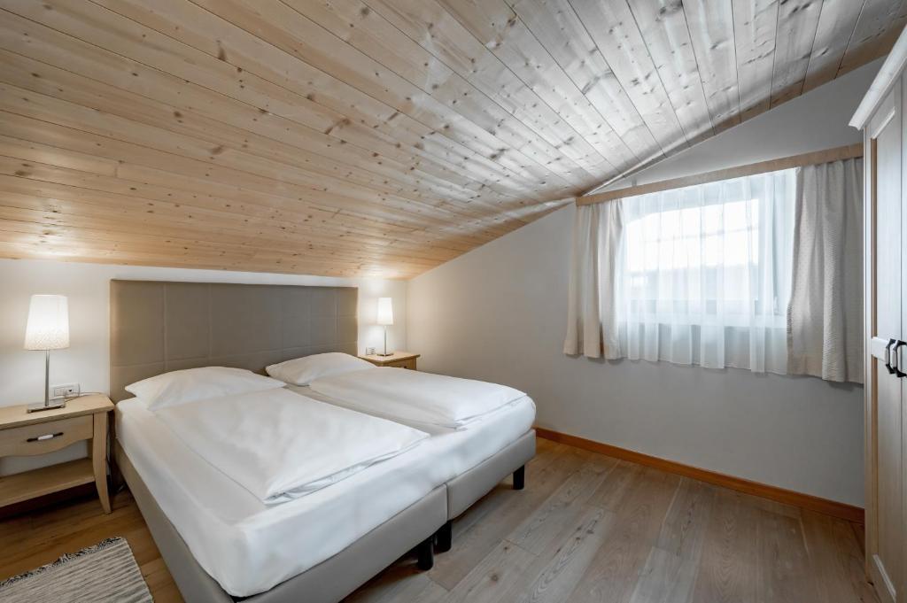 Posteľ alebo postele v izbe v ubytovaní Apartment Torri di Seefeld
