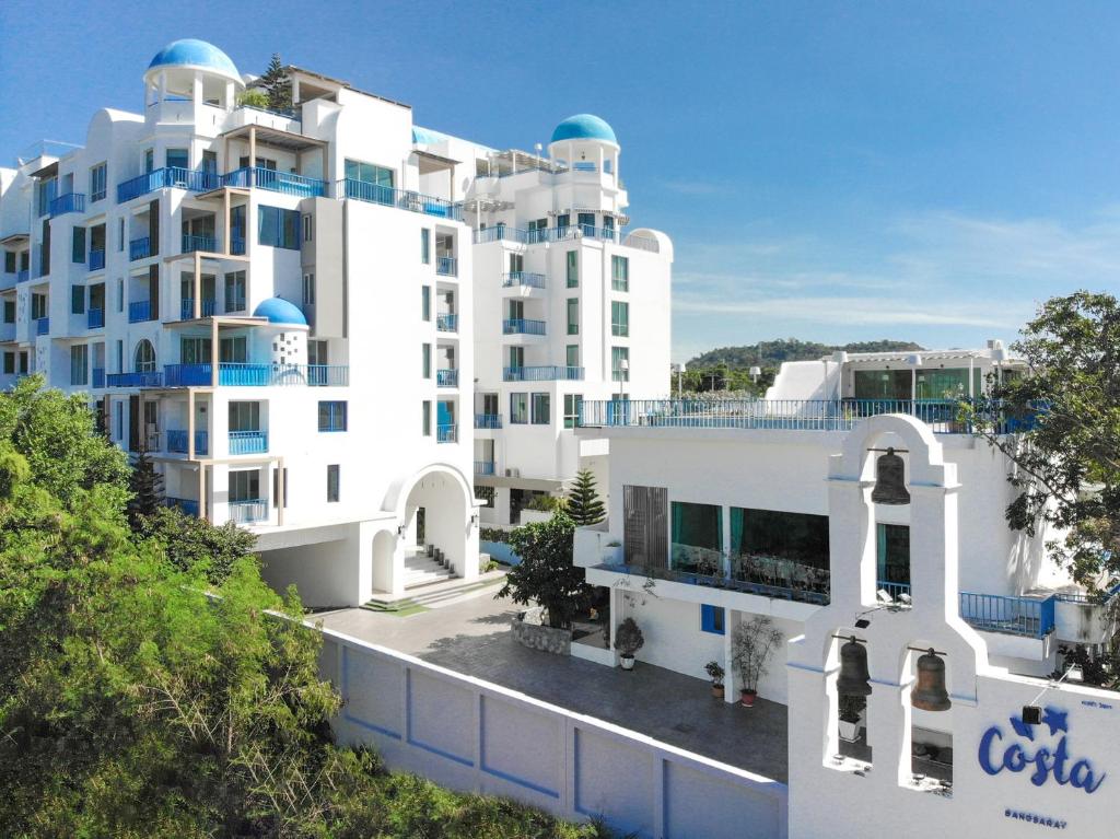 a white building with blue domes on top of it at Costa Beach Residence & Jacuzzi in Sattahip