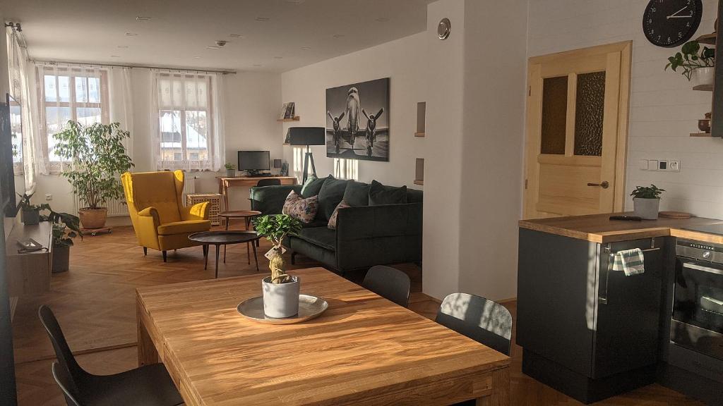 a living room with a couch and a table at Apartman692 in Vrchlabí