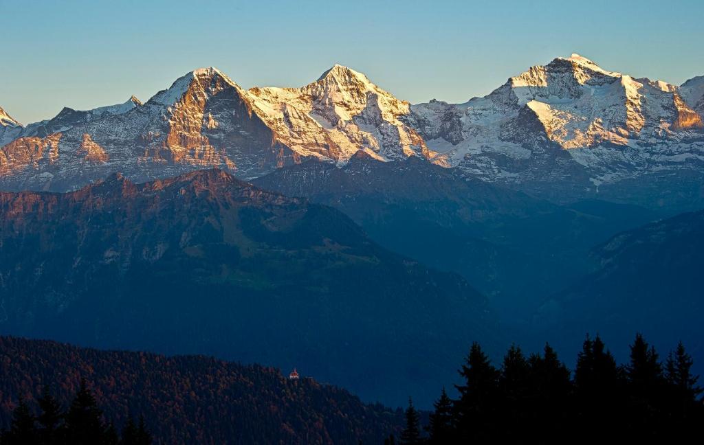 a group of mountains with snow on them at Hotel Fassbind Beausite in Beatenberg
